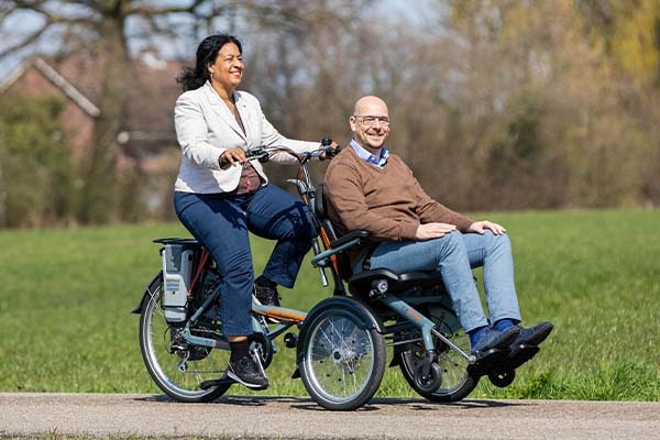A tricycle with passenger seat Van Raam wheelchair bike OPair