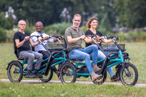 A tricycle with passenger seat Van Raam side-by-side tandem Fun2Go with duo bike trailer FunTrain