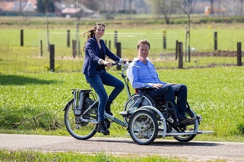 VeloPlus wheelchair bike together with one leg on bicycle Van Raam