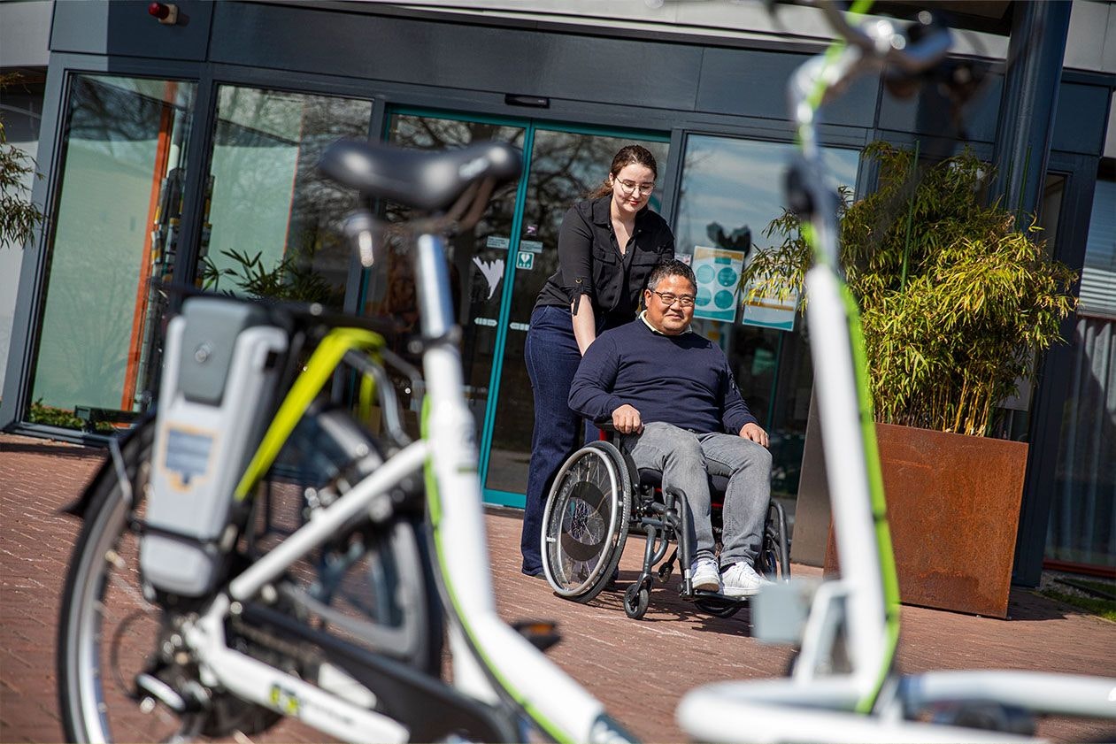 Cycling wheelchair user Van Raam VeloPlus bike with wheelchair