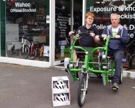 A community helps adapted cycling on a specialized bike A community helps adapted cycling on a specialized bike