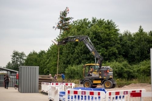 Placing maypole at new factory hall Van Raam