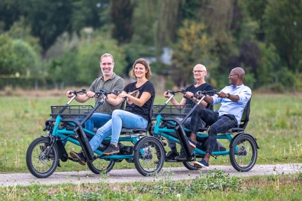 Riding with three or four persons on a tricycle funtrain side-by-side tandem