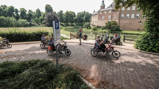 Elderly on tricycle tandems through the hills of Montferland