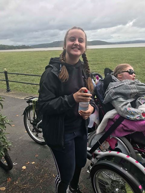 Sisters cycle with wheelchair transporter