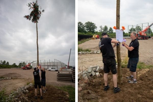 Attaching the poem on the maypole at new factory hall Van Raam