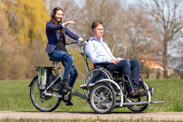 A tricycle with passenger seat Van Raam wheelchair transport bike VeloPlus